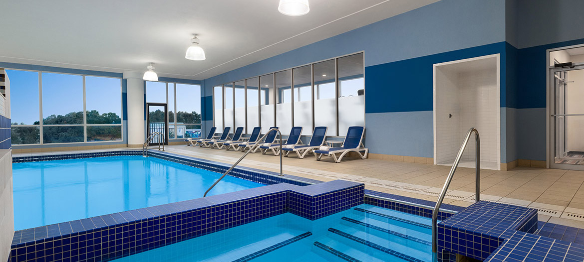 Indoor pool and hot tub, featuring clear water and a relaxing atmosphere for guests.