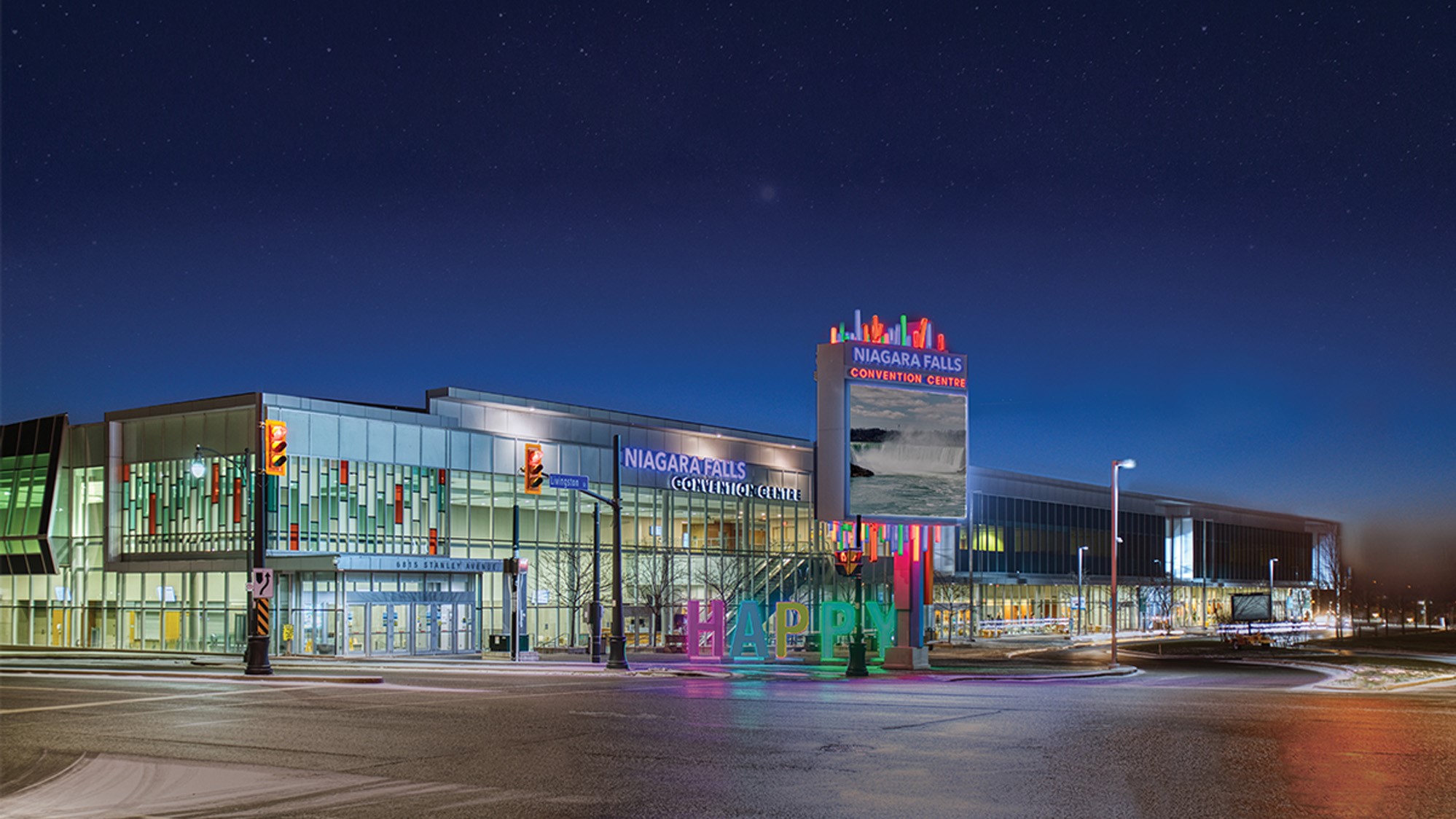 The Niagara Falls Convention Centre illuminated at night, featuring a prominent sign that stands out against the dark sky.