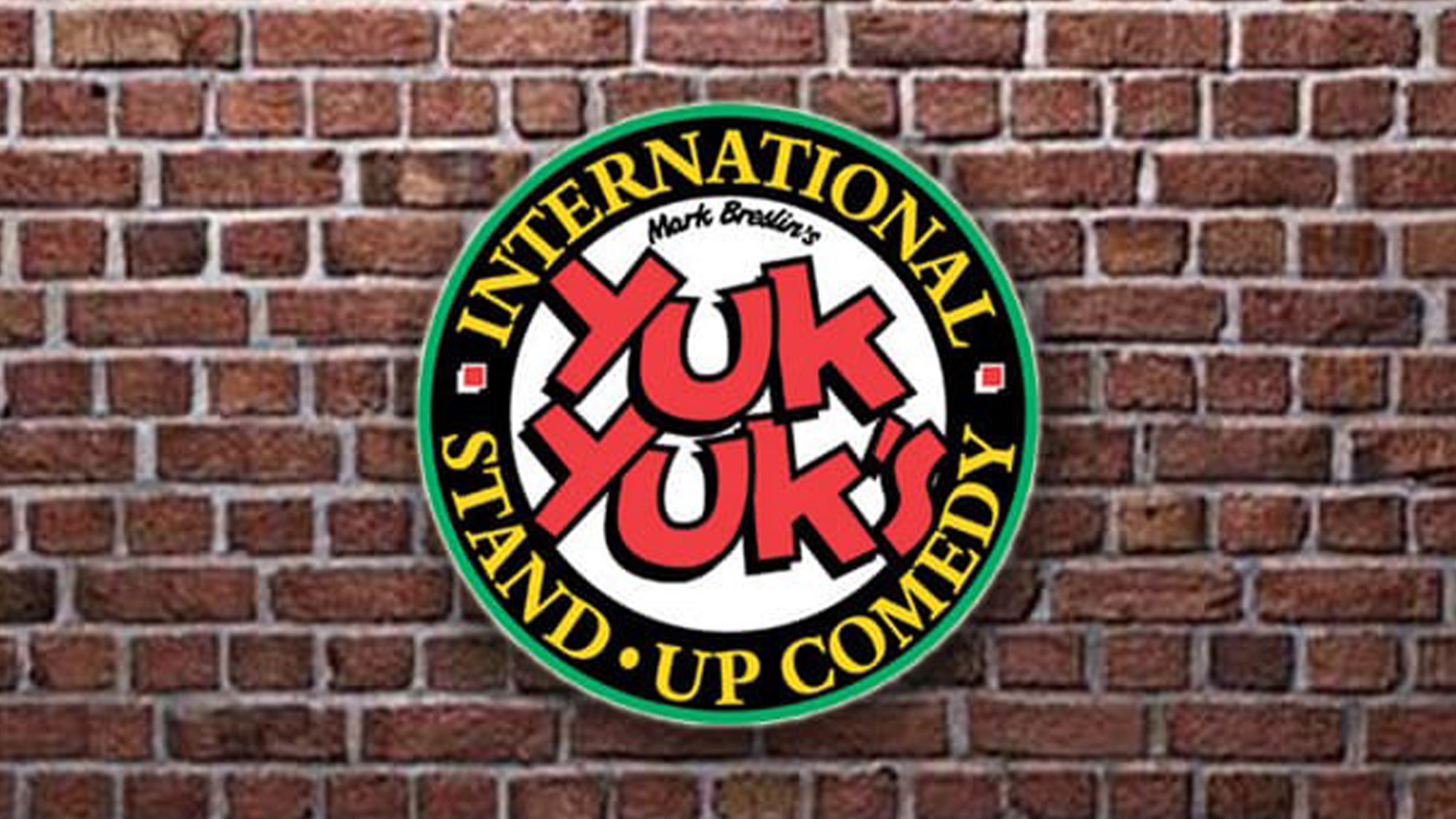 A stand-up comedy venue with comedians of different backgrounds, entertaining a diverse audience with humor.