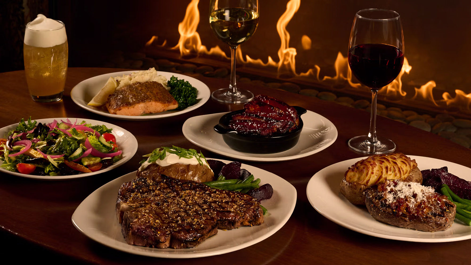 An assortment of beautifully arranged plates featuring a succulent steak alongside perfectly cooked salmon.