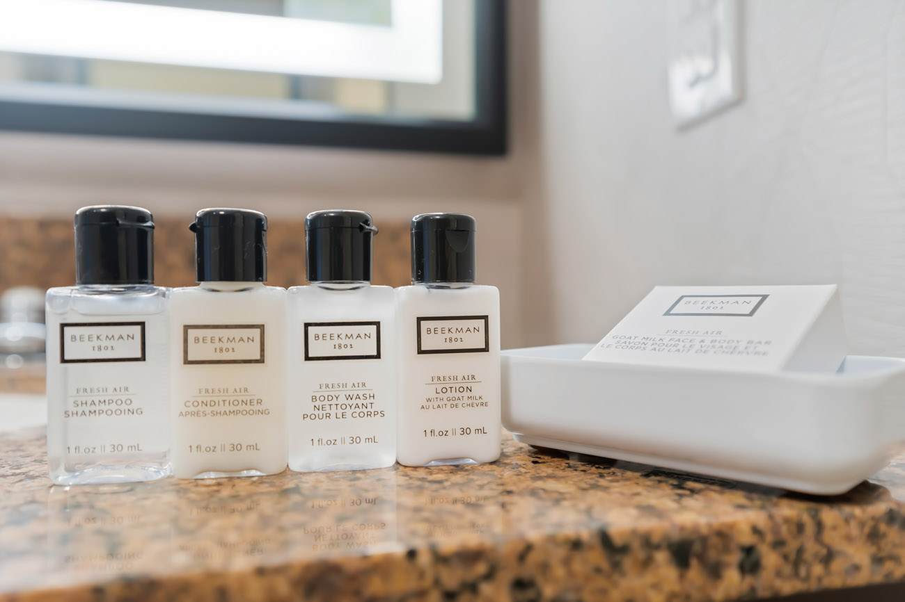 A collection of luxurious bathroom amenities including shampoo, conditioner, soap, and lotion arranged neatly on a countertop.